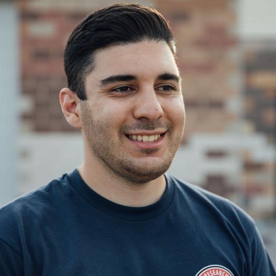man with dark hair smiling
